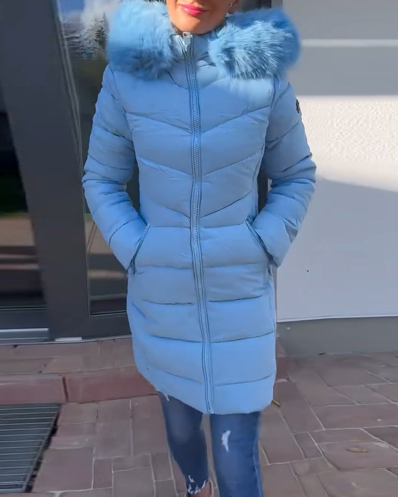 Women's blue quilted hooded coat with fluffy trim and zipped pockets