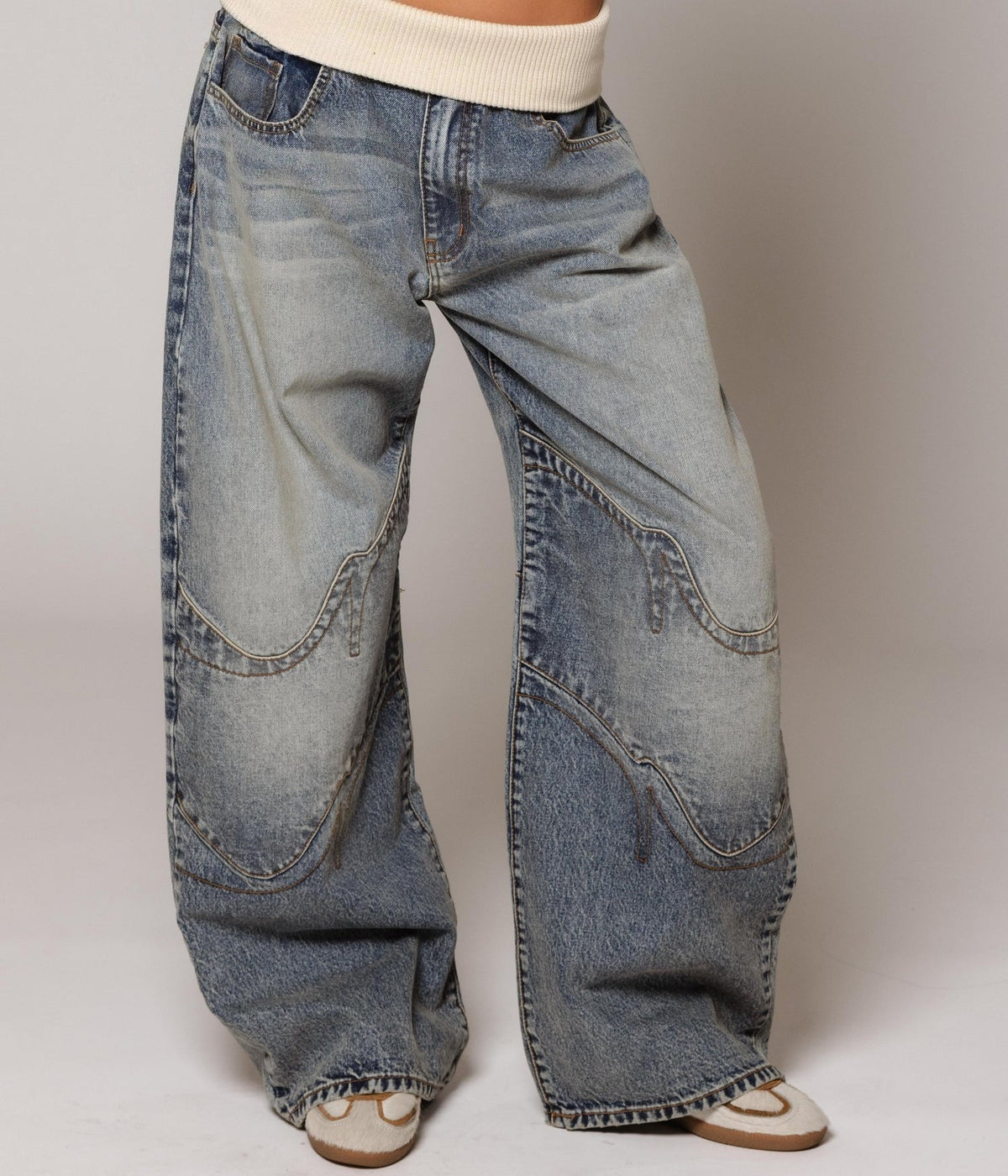 Women's washed blue wide-leg jeans with contrasting curved denim panels