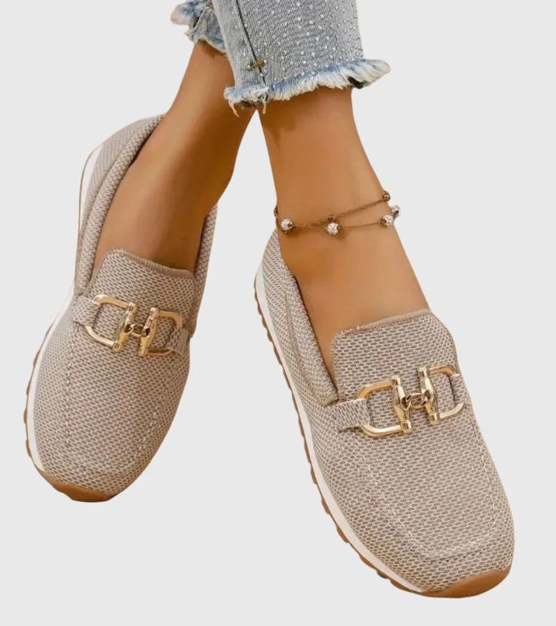 Women's textured slip-on loafers with decorative metal-tone buckles and ridged soles