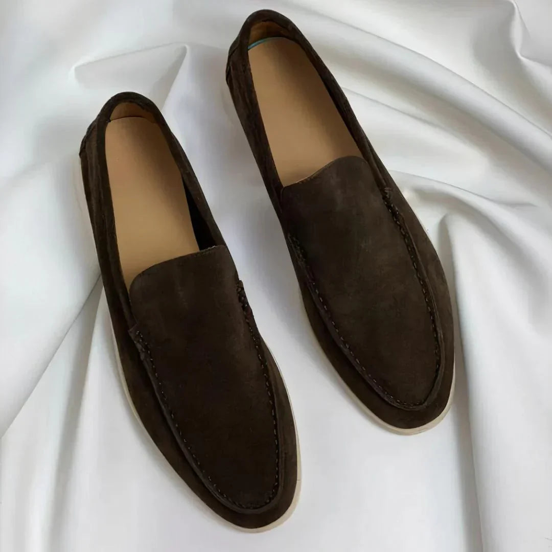 Men's slip-on loafers with rounded toes, stitched apron detailing and flat light-coloured soles