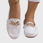 Women's flat slip-on loafers with moc toe stitching and decorative chain detail