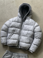 Men's hooded quilted puffer jacket shown in grey and black
