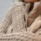 Women's quilted jacket with textured knitted sleeves, stand collar and zip front