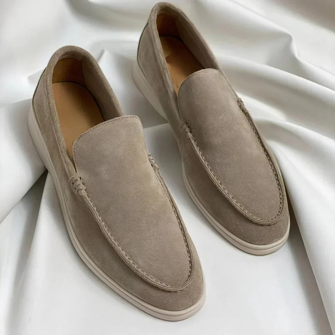 Men's slip-on loafers with rounded toes, stitched apron detailing and flat light-coloured soles