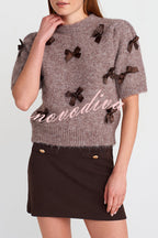 Women's taupe knitted crop top with dark bow details and short sleeves