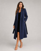 Women's navy longline trench coat with lapels, long sleeves, side pockets and tie belt