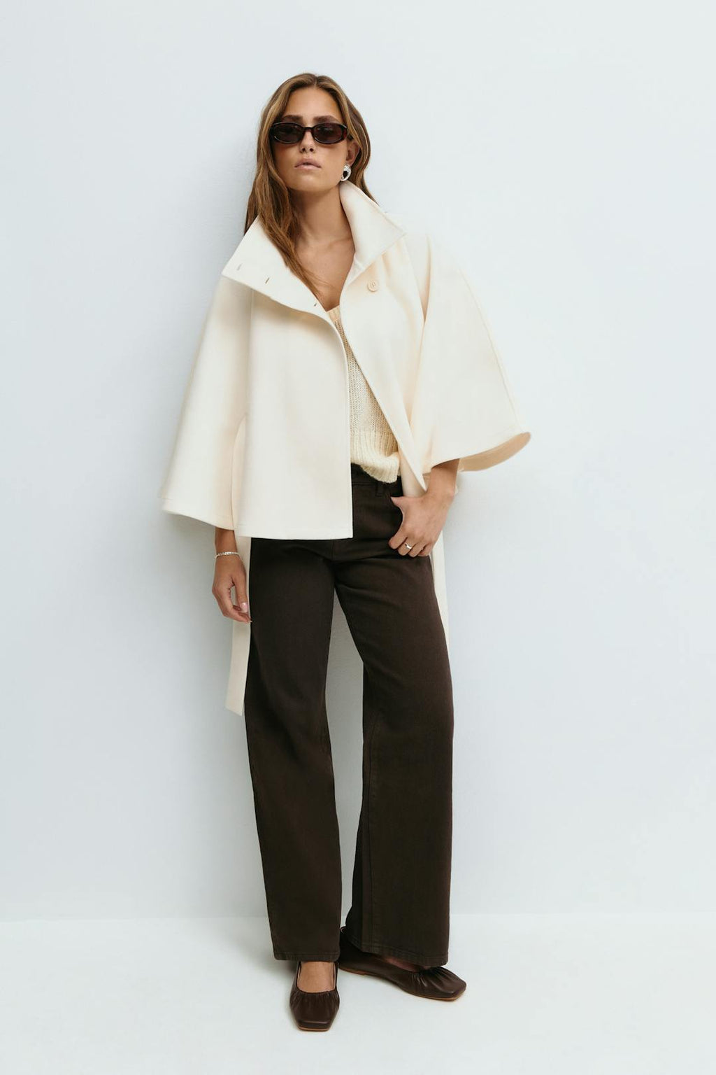 Women's cape coat with high collar, button front and tied waist belt