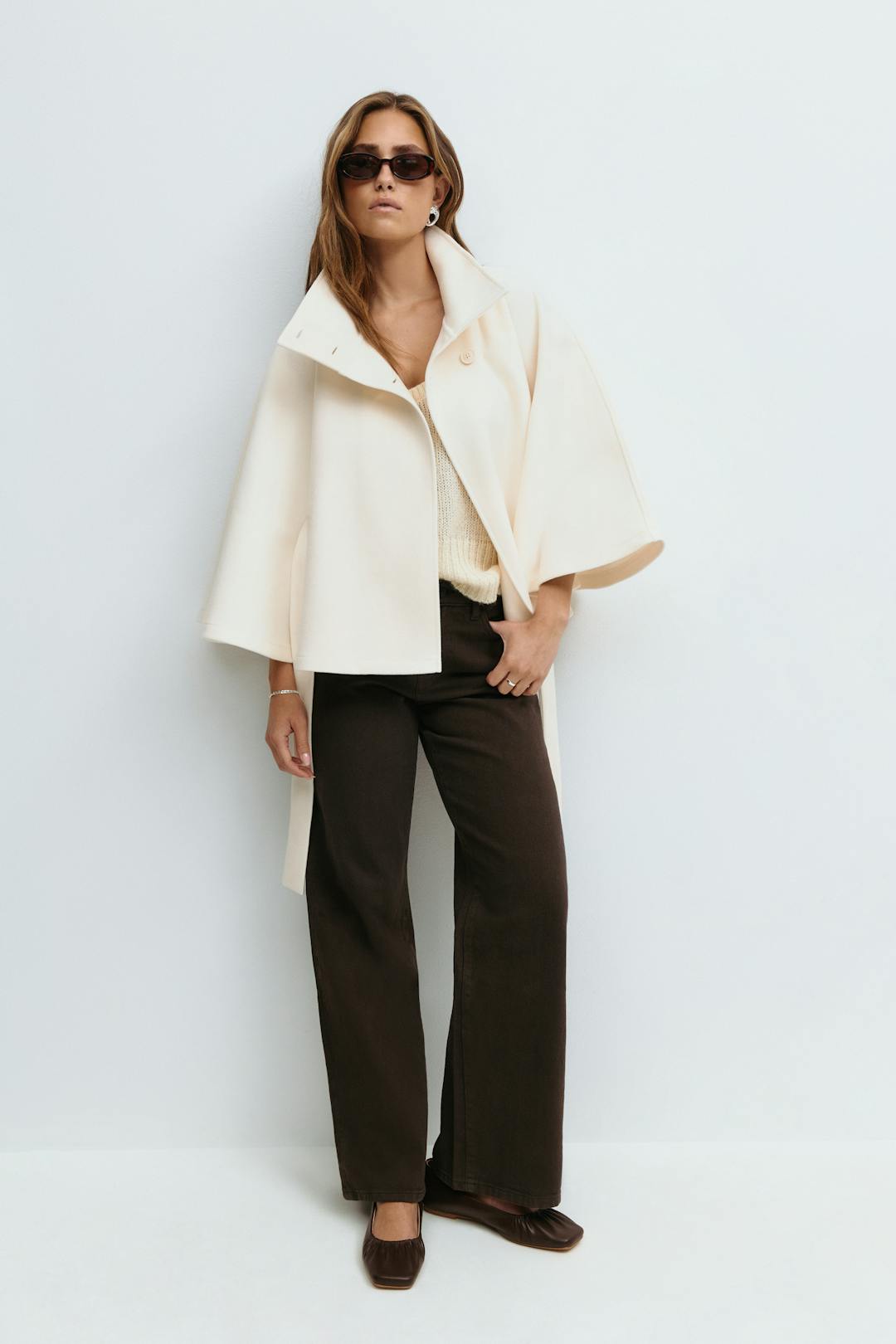 Women's cape coat with high collar, button front and tied waist belt