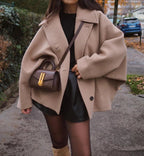 Women's oversized short coat with wide collar, long sleeves, buttons and front pockets