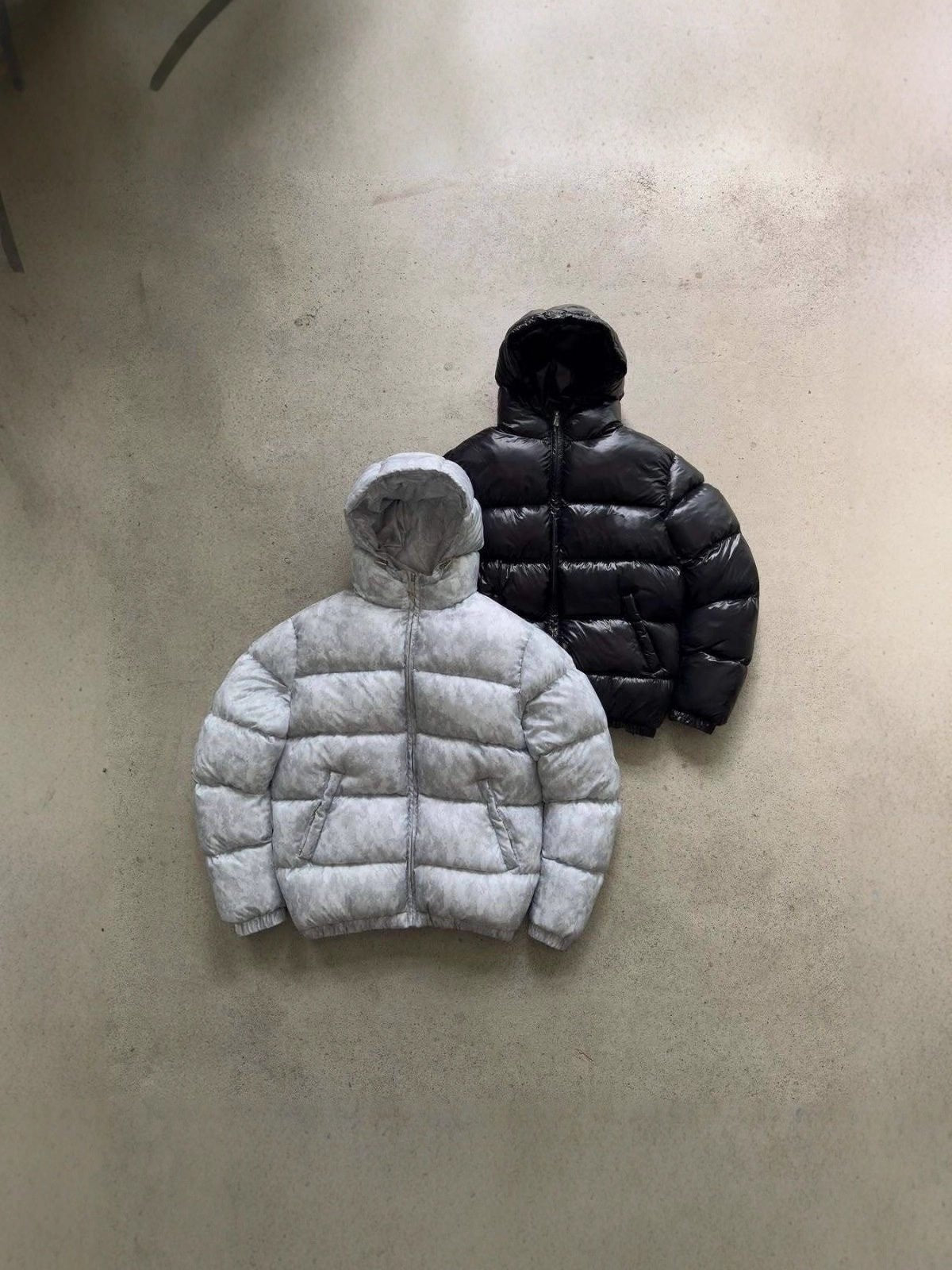 Men's hooded quilted puffer jacket shown in grey and black
