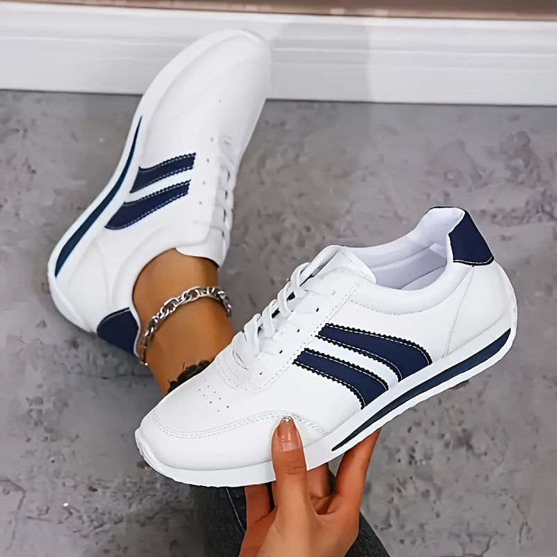 White lace-up trainers with navy side stripes and a flat sole