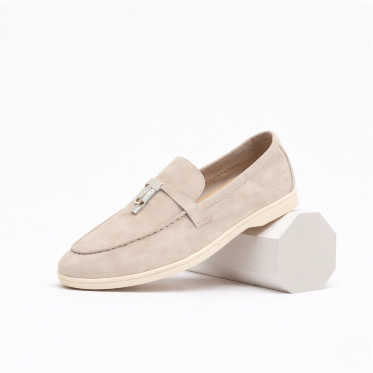 Women's classic slip-on loafer with rounded toe, flat sole and decorative metal trim