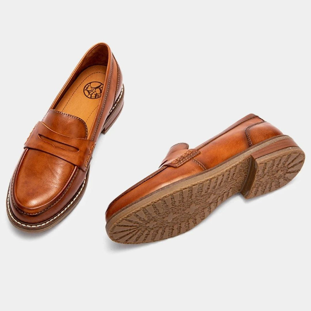 Men's slip-on penny loafers with rounded toes, stitched soles and low flat heels