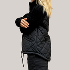 Women's quilted jacket with textured knitted sleeves, stand collar and zip front