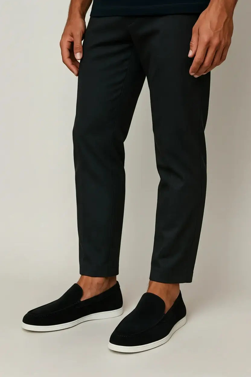Men's slip-on loafers with rounded toes, stitched apron detailing and flat light-coloured soles