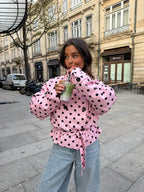 Women's pink cropped jacket with black polka dots, high collar and tie waist