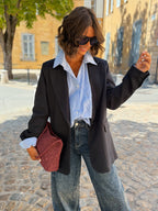 Women's black striped blazer with notched lapels and long sleeves