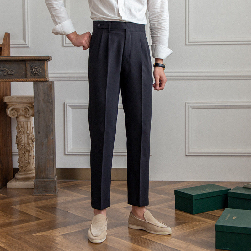 Women's high-waisted pleated straight-leg trousers with belt loops and long hems