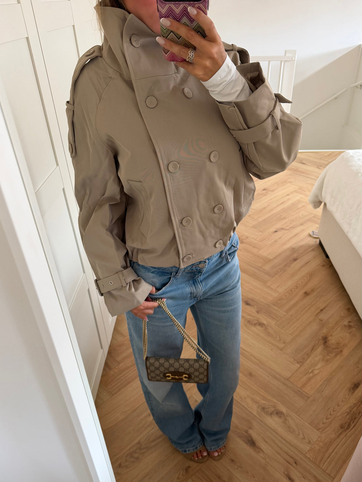 Women's beige cropped double-breasted trench jacket with long sleeves and adjustable cuffs