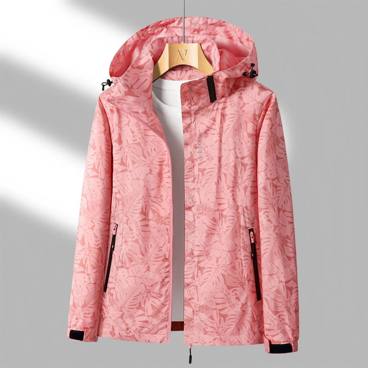 Women's hooded abstract patterned windbreaker jacket with long sleeves and zipped pockets