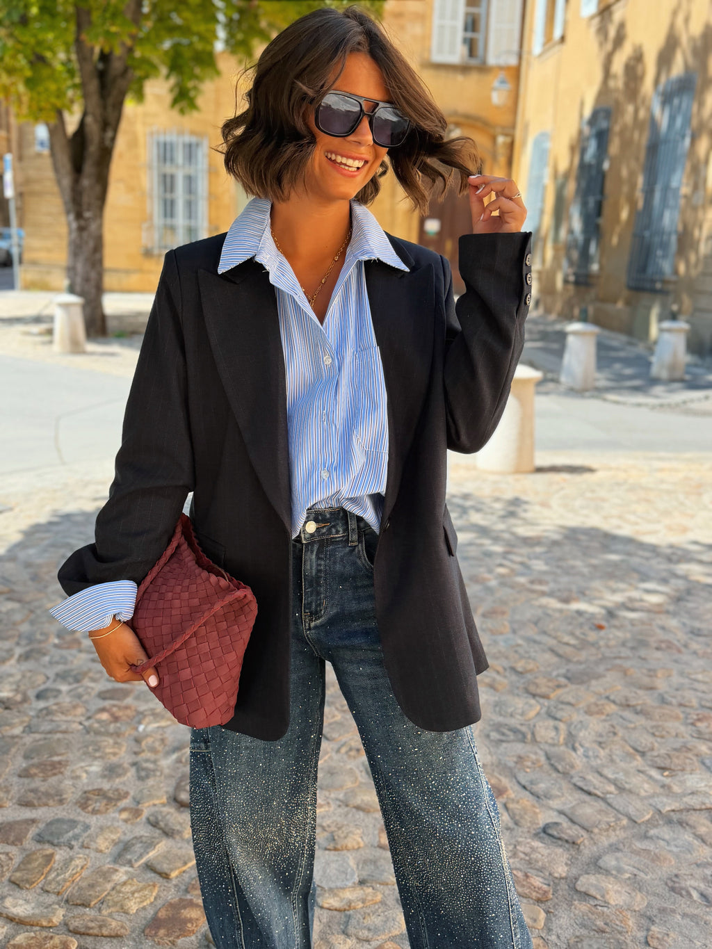Women's black striped blazer with notched lapels and long sleeves