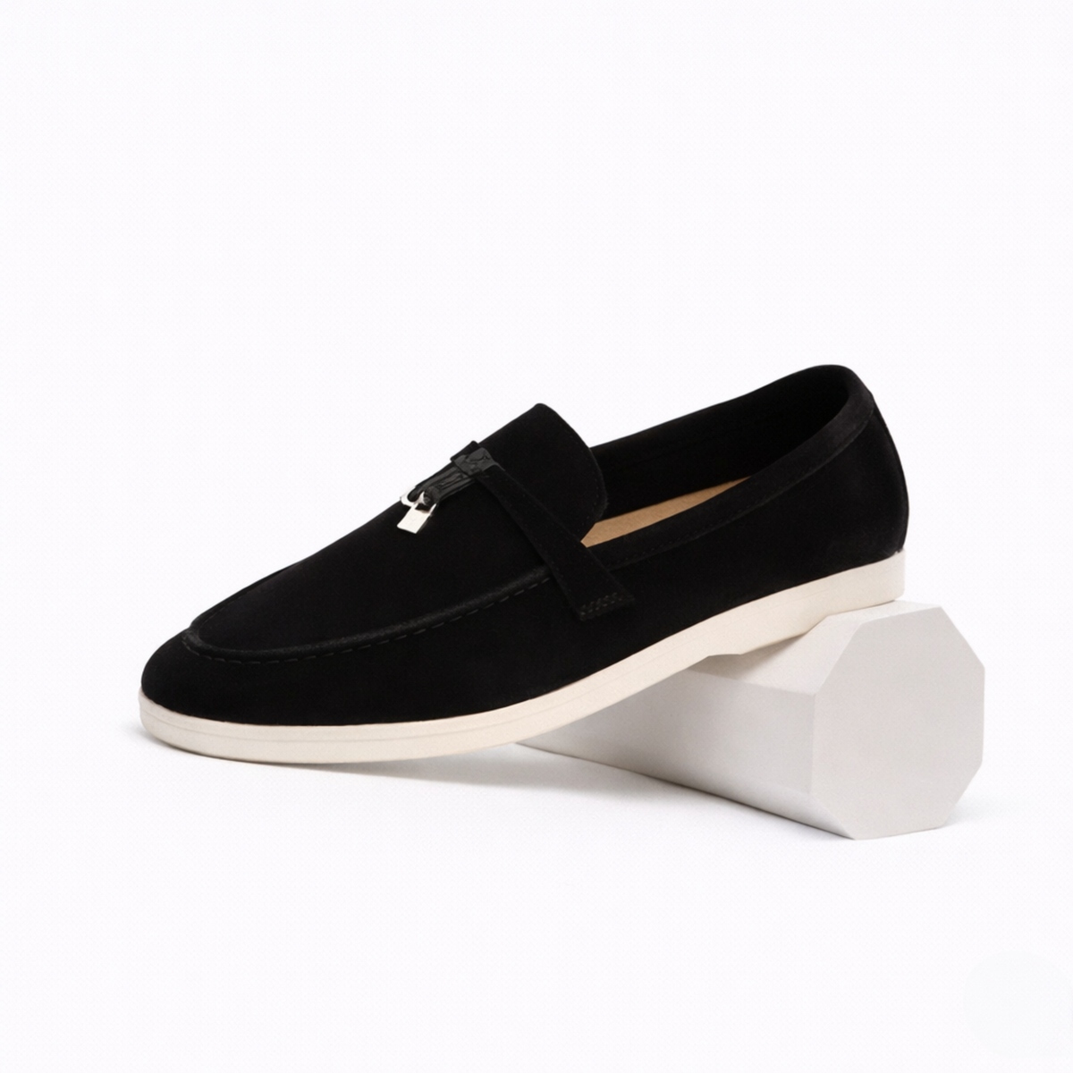 Women's classic slip-on loafer with rounded toe, flat sole and decorative metal trim
