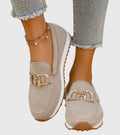 Women's textured slip-on loafers with decorative metal-tone buckles and ridged soles