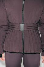 Women's hooded quilted ski jacket with belted waist and long sleeves