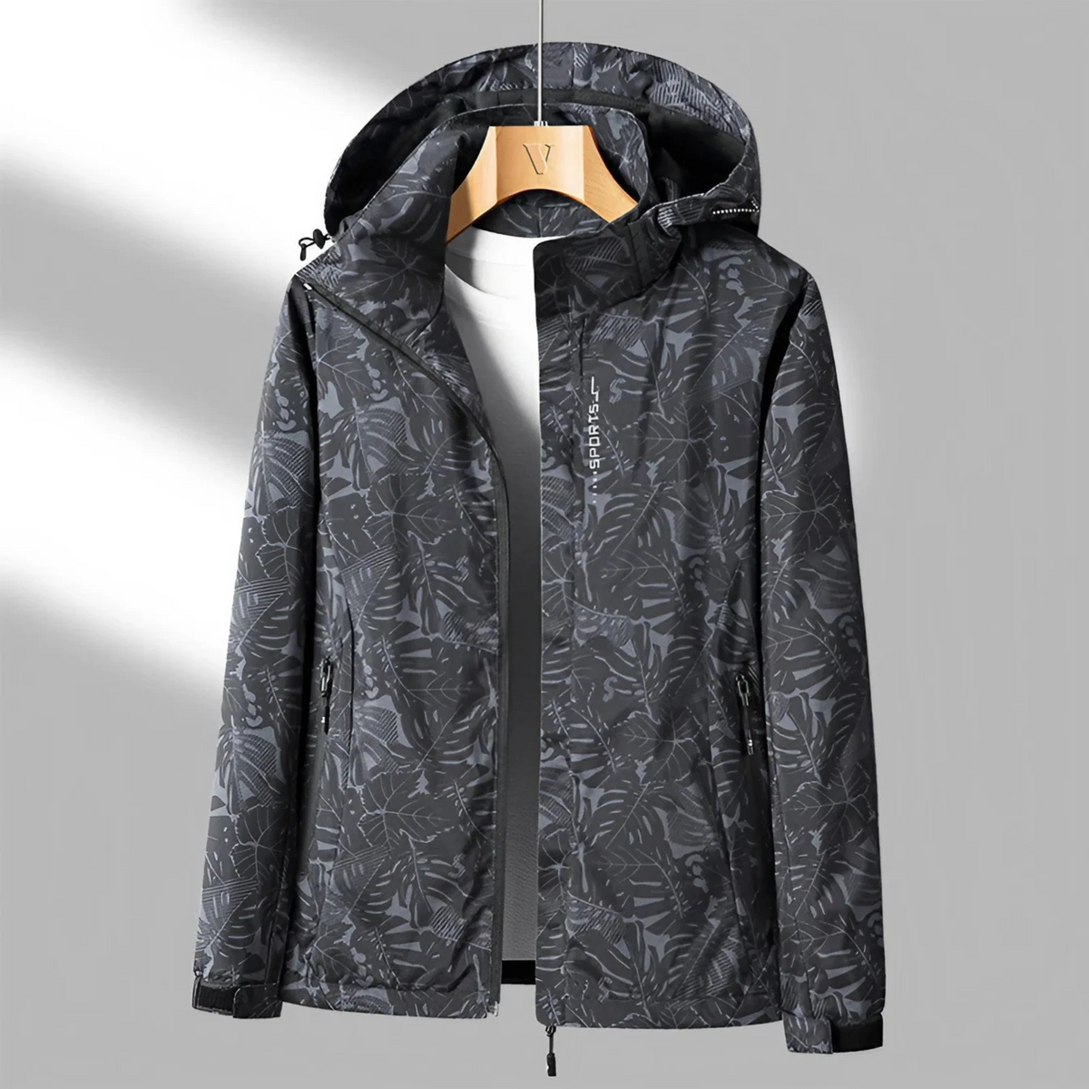 Women's hooded abstract patterned windbreaker jacket with long sleeves and zipped pockets