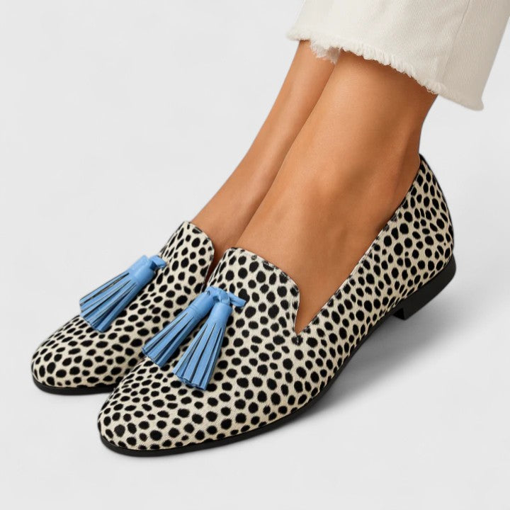 Women's animal print loafers with blue tassel trims and low heels