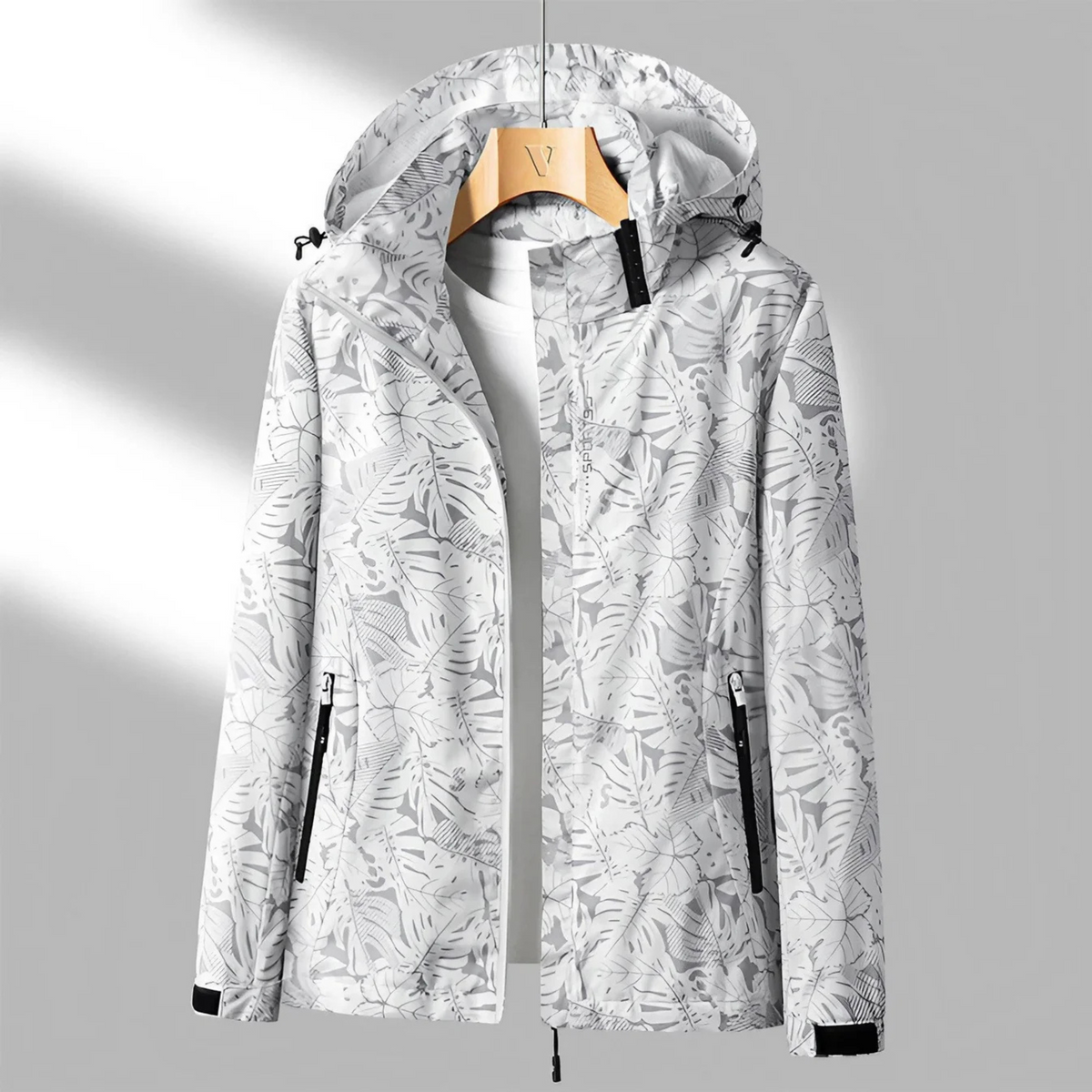Women's hooded abstract patterned windbreaker jacket with long sleeves and zipped pockets