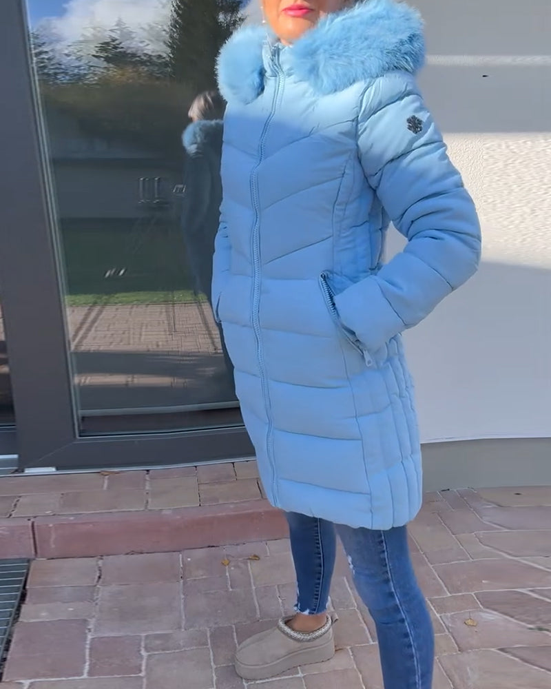 Women's blue quilted hooded coat with fluffy trim and zipped pockets