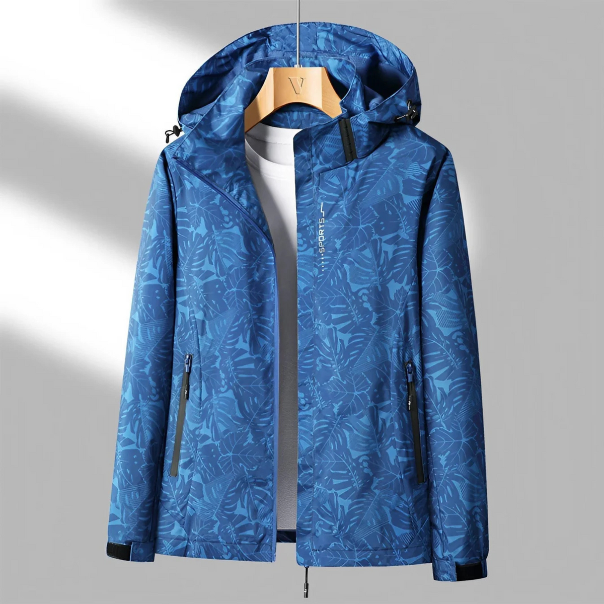 Women's hooded abstract patterned windbreaker jacket with long sleeves and zipped pockets
