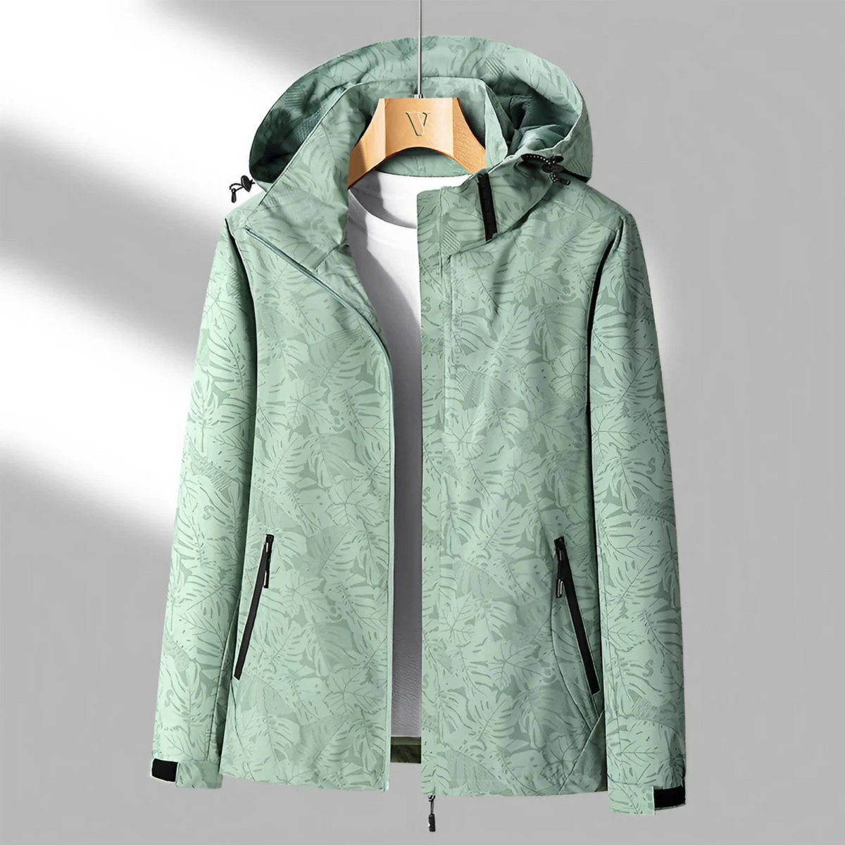 Women's hooded abstract patterned windbreaker jacket with long sleeves and zipped pockets
