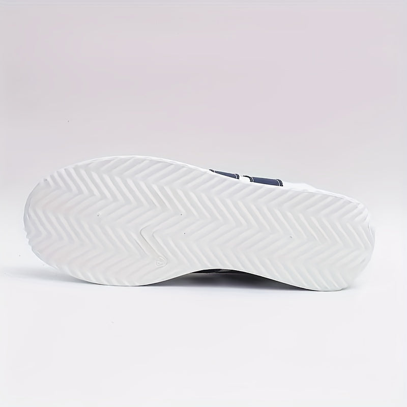 White lace-up trainers with navy side stripes and a flat sole