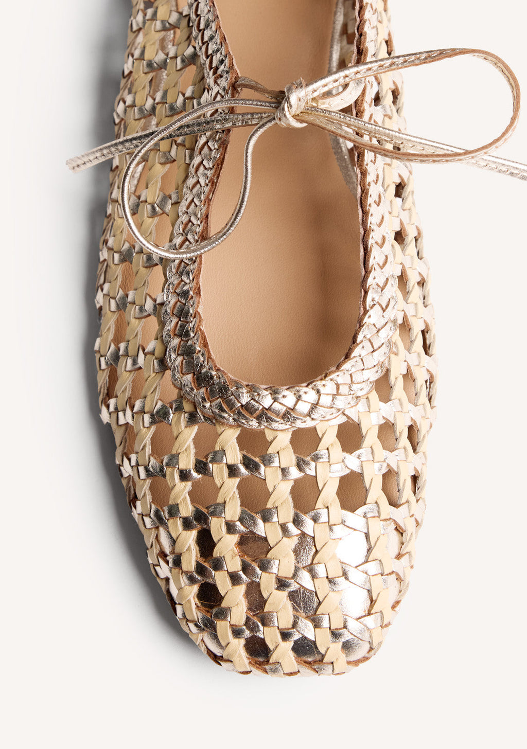 Gold woven ballet flats with ankle tie straps and low heels