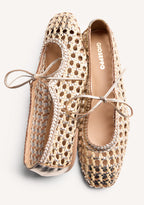 Gold woven ballet flats with ankle tie straps and low heels