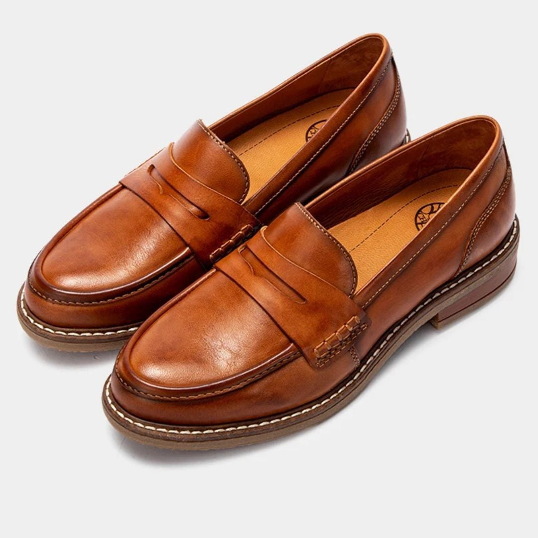 Men's slip-on penny loafers with rounded toes, stitched soles and low flat heels
