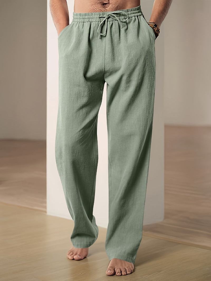 Men's plain straight-leg trousers with an elasticated drawstring waist and side pockets