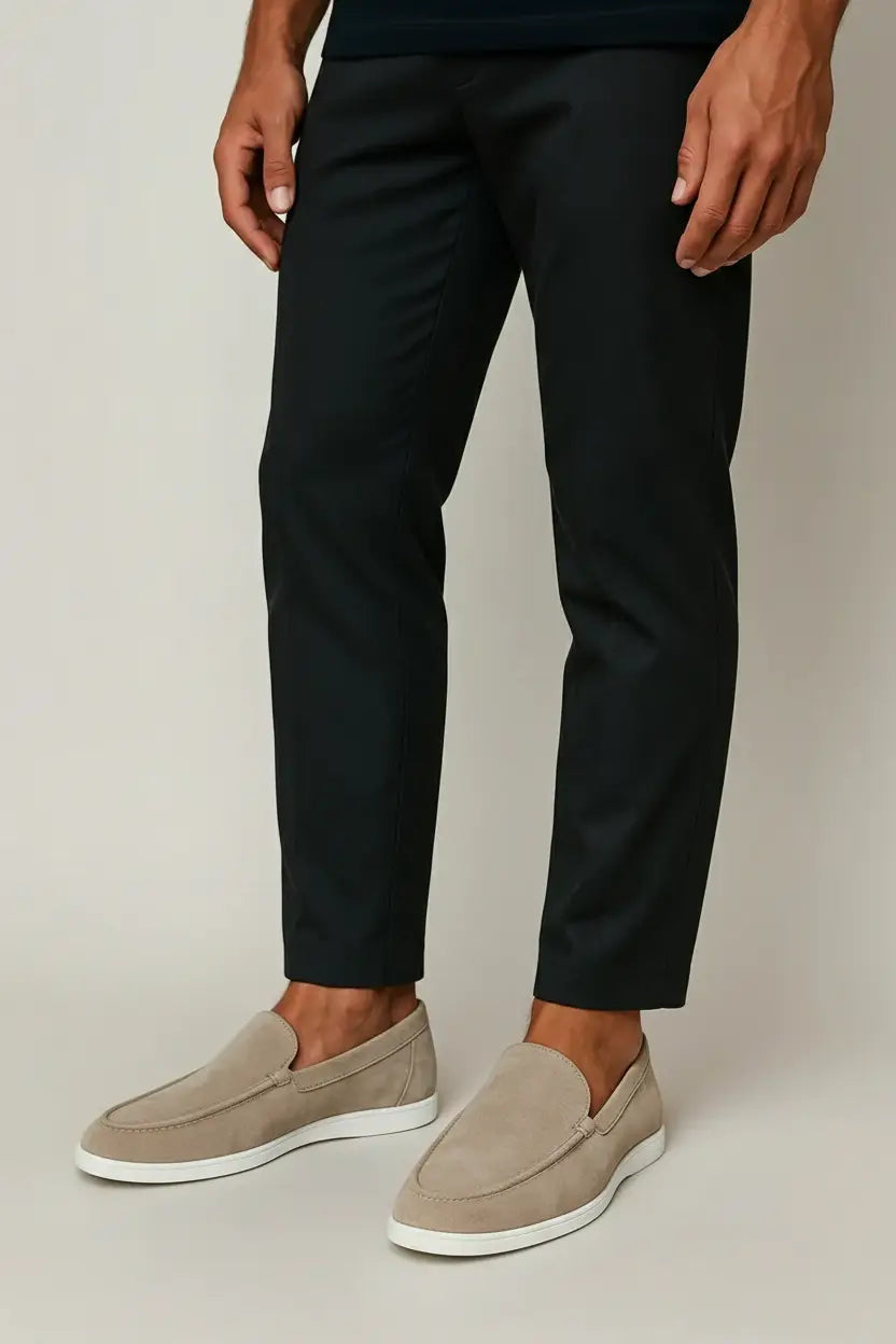 Men's slip-on loafers with rounded toes, stitched apron detailing and flat light-coloured soles