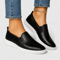 Women's black textured slip-on loafers with white flat soles