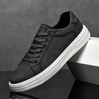 Low-top camouflage trainers with lace-up front and white sole