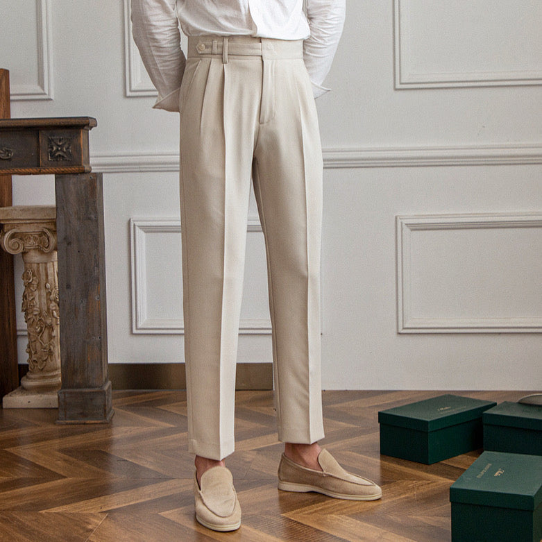 Women's high-waisted pleated straight-leg trousers with belt loops and long hems