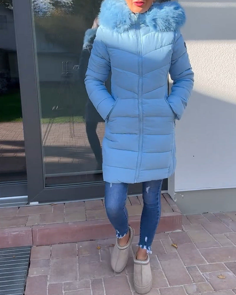 Women's blue quilted hooded coat with fluffy trim and zipped pockets