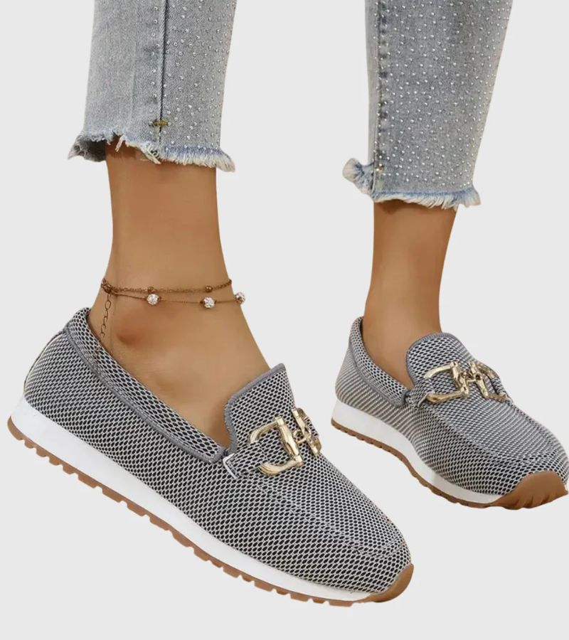 Women's textured slip-on loafers with decorative metal-tone buckles and ridged soles