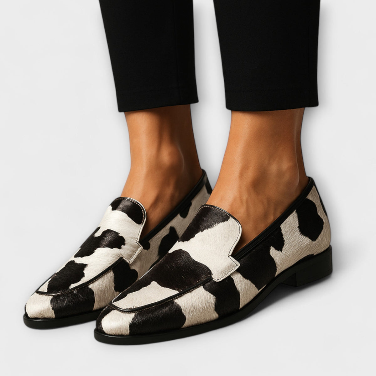 Women's cow print slip-on loafers with almond toes and low heels