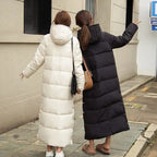 Women's long quilted puffer coat with hood and side pockets
