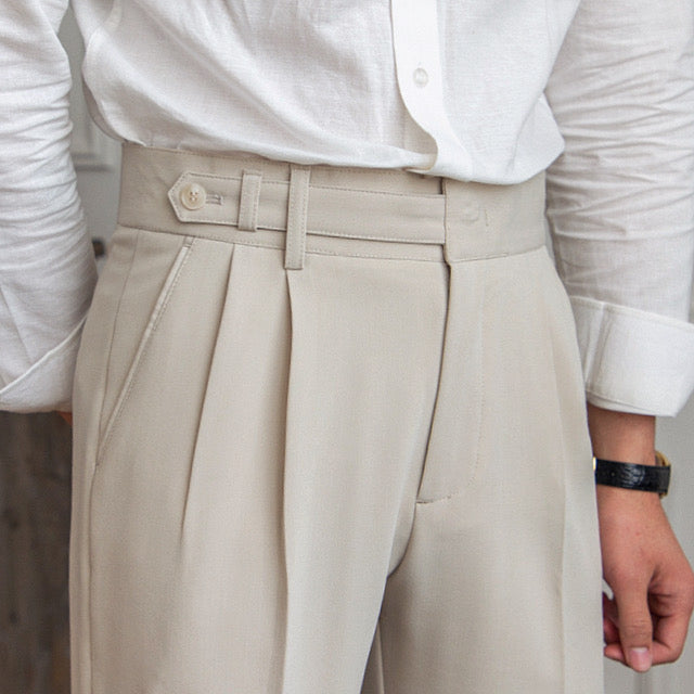 Women's high-waisted pleated straight-leg trousers with belt loops and long hems