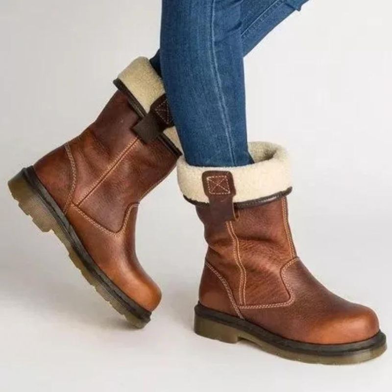 Brown ankle boots with cream fur-style cuffs, buckle trim and lugged soles