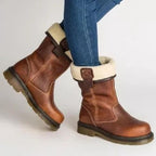 Brown ankle boots with cream fur-style cuffs, buckle trim and lugged soles